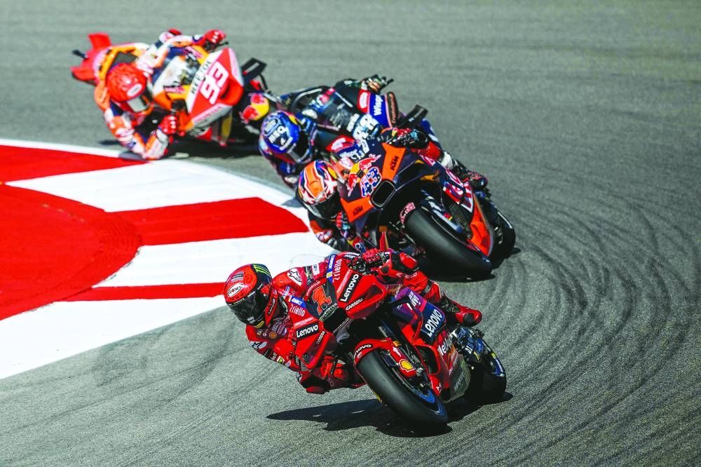 From front: Ducati’s Francesco Bagnaia, KTM’s Jack Miller, Aprilia’s Miguel Oliveira and Honda’s Marc Marquez compete in the sprint race during the MotoGP Portuguese Grand Prix at the Algarve International Circuit in Portimao. (AFP)