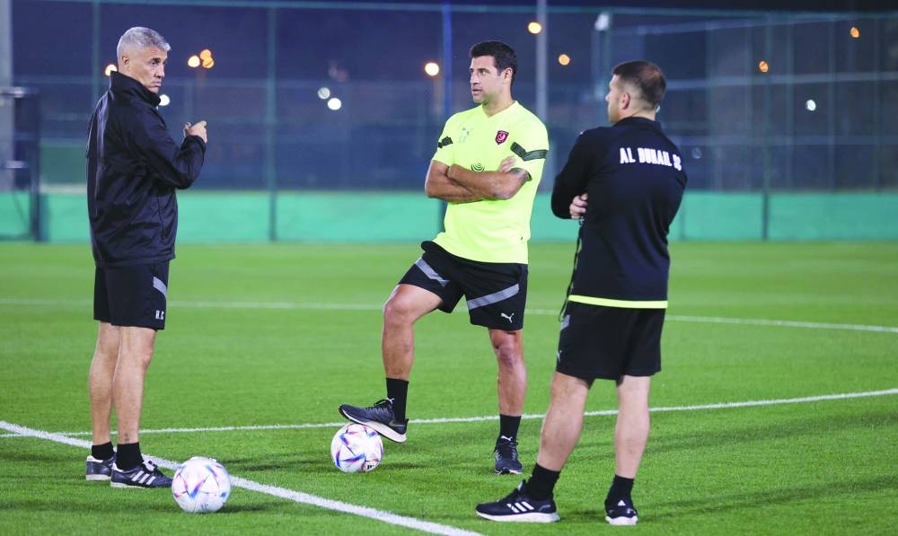Al Duhail’s coach Hernan Crespo (left) talks to his staff during a training session on Monday.
