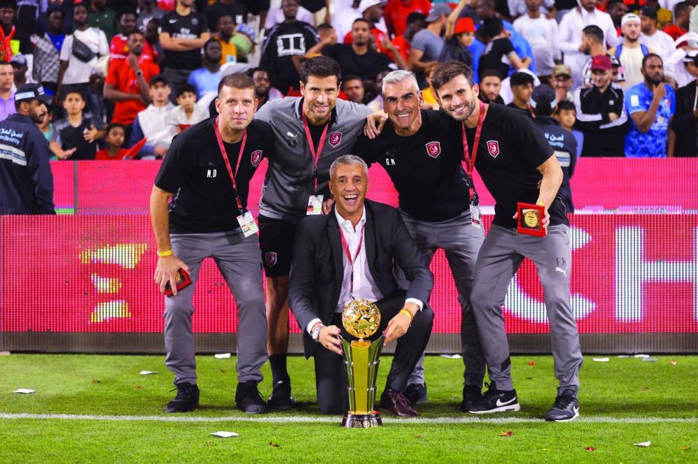 Al Duhail head coach Hernan Crespo celebrates with his support staff.
