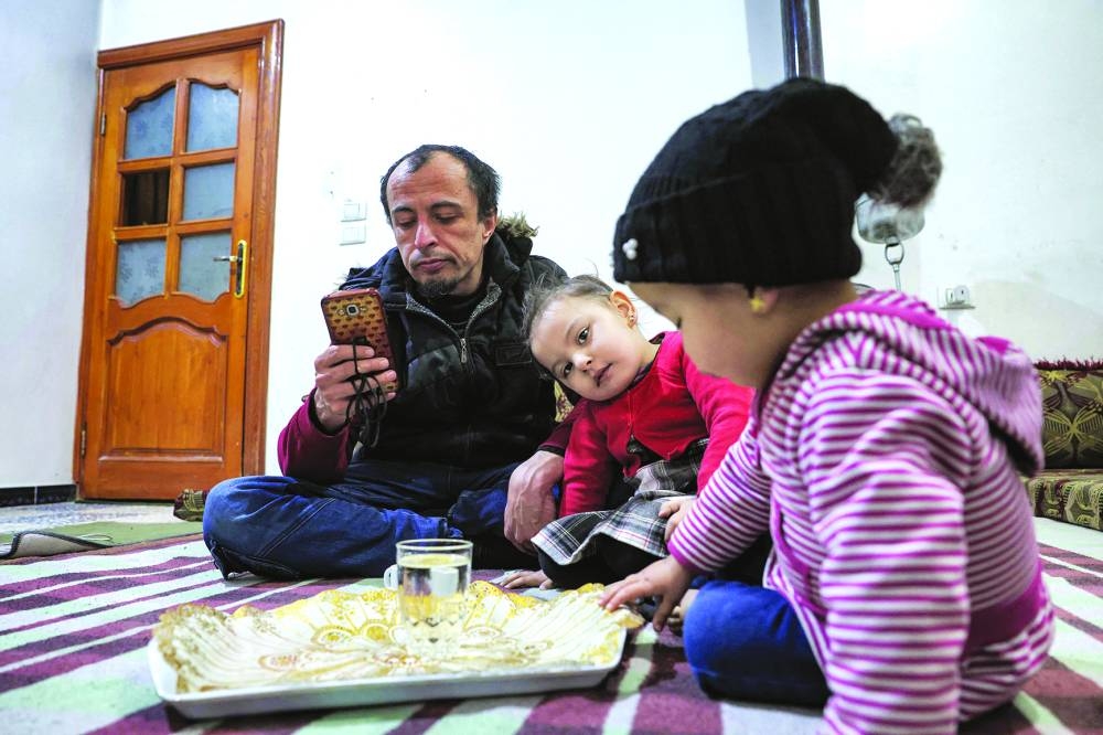Islam Shakhbanov with his children at his home in Syria's rebel-held town of al-Dana, in the northwestern Idlib province, near the Turkish-Syrian border.
