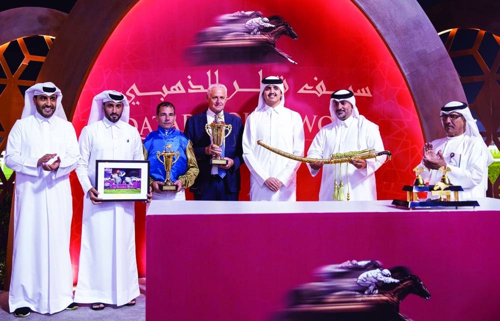 HE Sheikh Thani bin Hamad al-Thani presented the Group 1 P/A Qatar Gold Sword to Ali bin Yousef al-Rumaihi, General Manager of Wathnan Racing, owner of Abbes at the Al Rayyan Racecourse on Thursday night. QREC Chairman Issa bin Mohamed al-Mohannadi is also seen in the picture. PICTURES: Juhaim 
