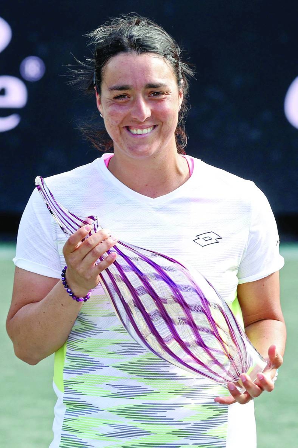 Ons Jabeur of Tunisia poses with the trophy after defeating Belinda Bencic of Switzerland during the final of the Charleston Open at Credit One Stadium in Charleston, South Carolina. (AFP)