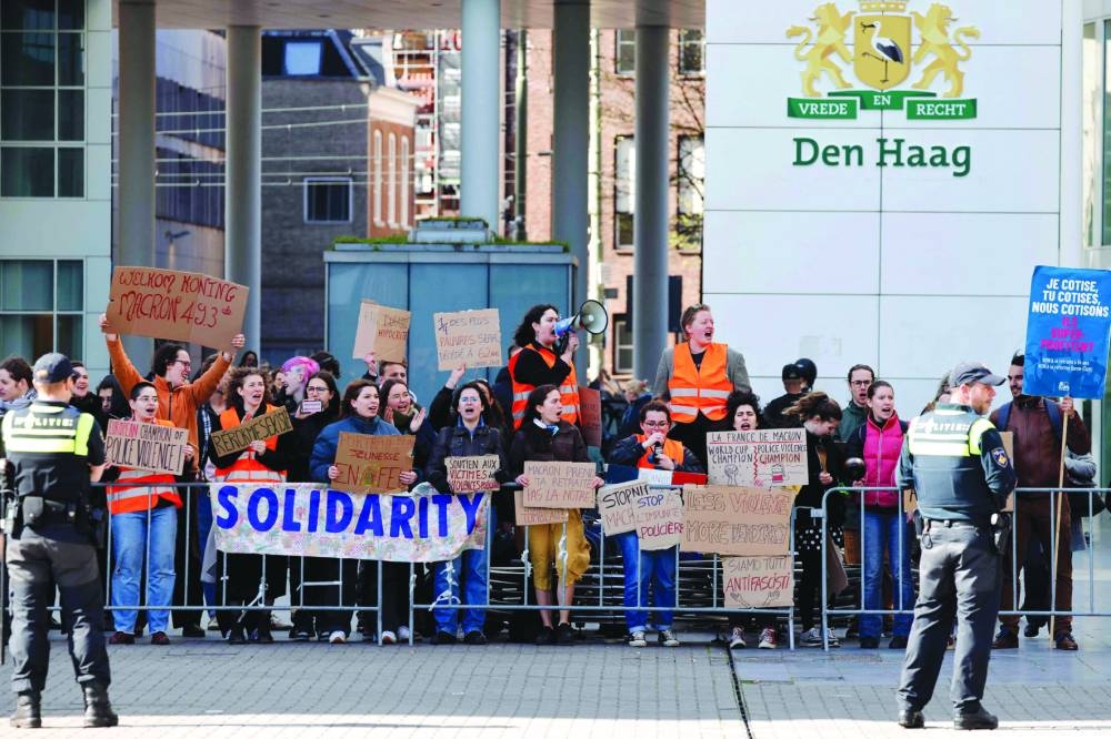 Students demonstrate against the French government's pensions reform outside the venue of a meeting between the French president and the Dutch Senate president in The Hague.