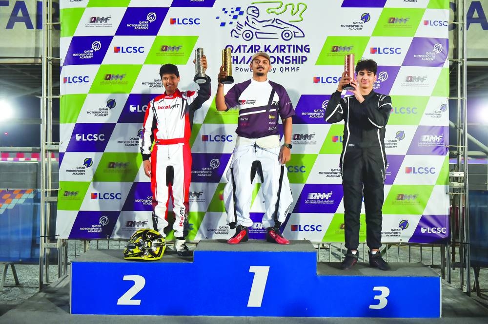 Winner Faesal al-Yafei (centre), runner-up Bader al-Sulaiti (left) and third-placed Taha Hassiba pose with their trophies during the third round of the Qatar Karting Championship at Lusail Circuit Sports Club’s (LCSC) Karting Track on Tuesday.