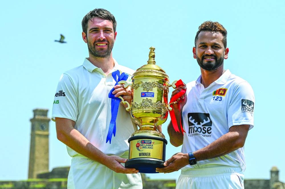 Sri Lanka's captain Dimuth Karunaratne (right) and Ireland's captain Andrew Balbirnie pose with the Test trophy on Saturday, on the eve of their first Test in Galle. (AFP)