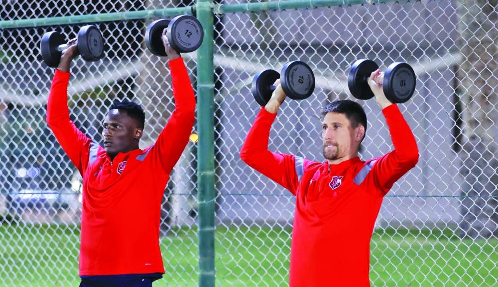 Al Duhail’s Federico Fernandez (right) and Michael Olunga train on the eve of their match against Al Rayyan.