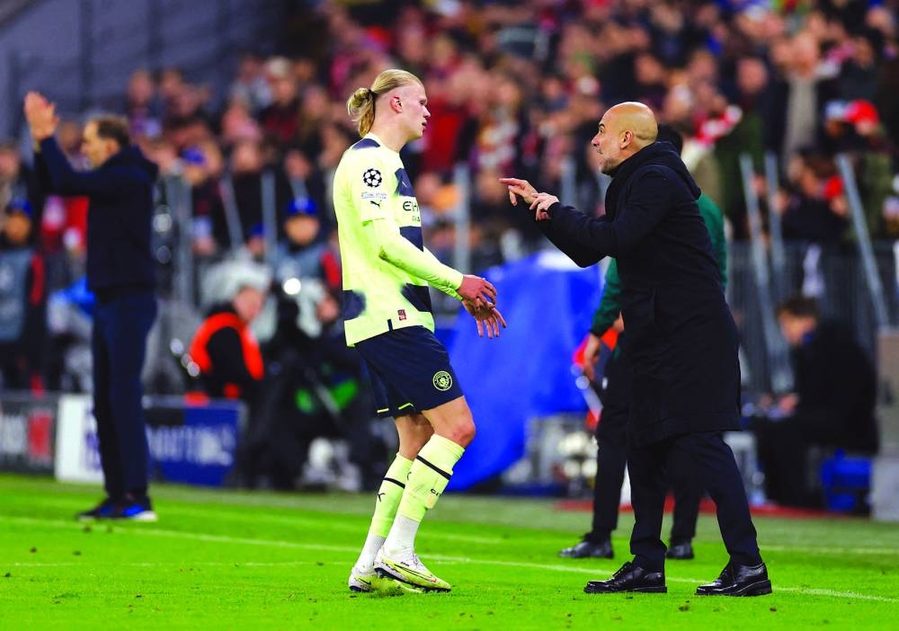 Manchester City manager Pep Guardiola (right) gives instructions to Erling Haaland during the Champions League second leg quarter-final at the Allianz Arena in Munich on Tuesday. (Reuetrs)