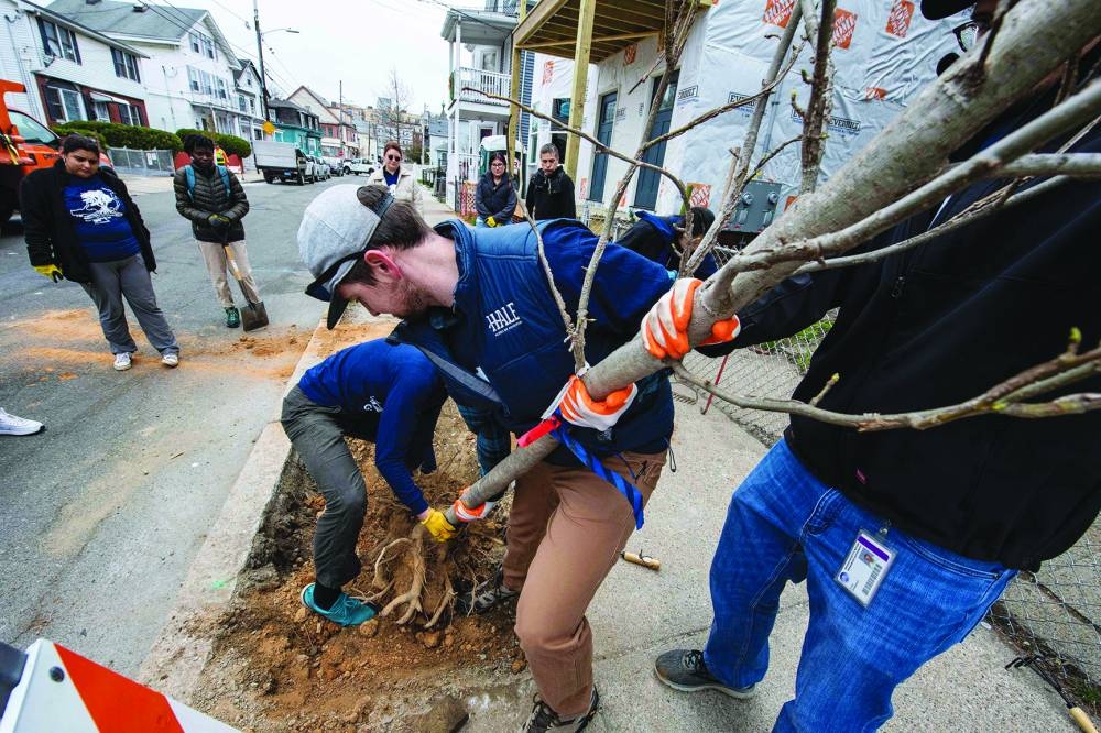 People plant a tree in Chelsea, Massachusetts, to mark Earth Day. (AFP)
