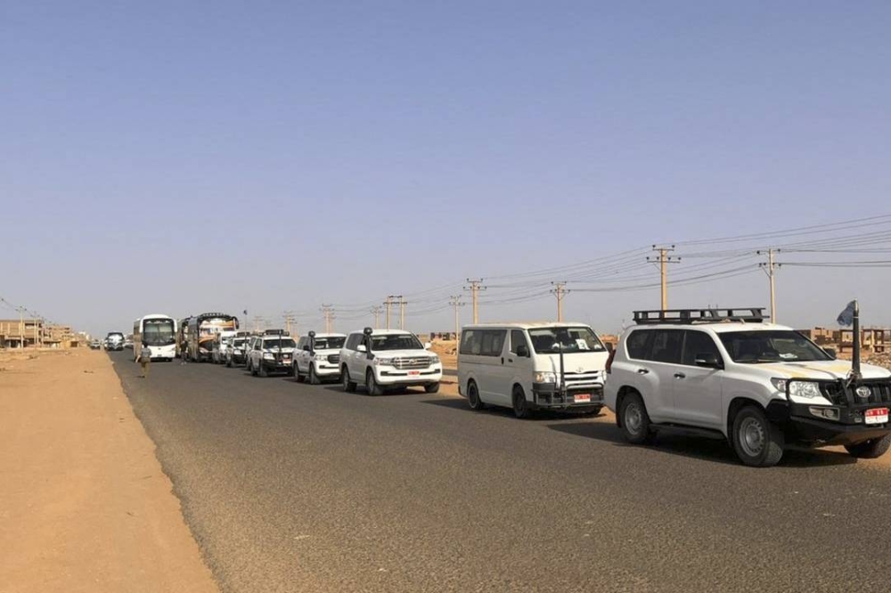 A convoy leaving Khartoum advances on a road towards Port Sudan, on April 23, 2023, as people flee the battle-torn Sudanese capital. AFP 