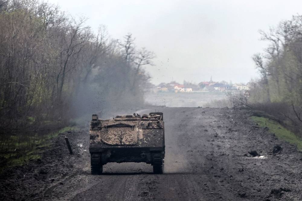 A Ukrainian soldier rides in a BMP infantry fighting vehicle near the town of Bakhmut, in Ukraine’s Donetsk region, amid the Russian invasion.