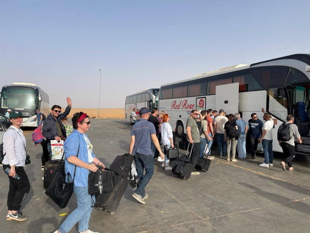 Ukrainian civilians wait to board a bus after getting evacuated, in Argeen, Sudan . GUR Press Service/Handout via REUTERS 