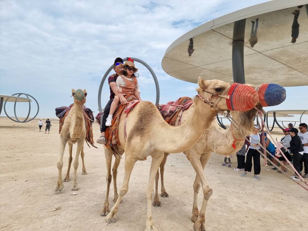 Camel rides offer a unique experience for visitors at 'Shadows Travelling on the Sea of the Day' during the Eid holiday. PICTURE: Joey Aguilar