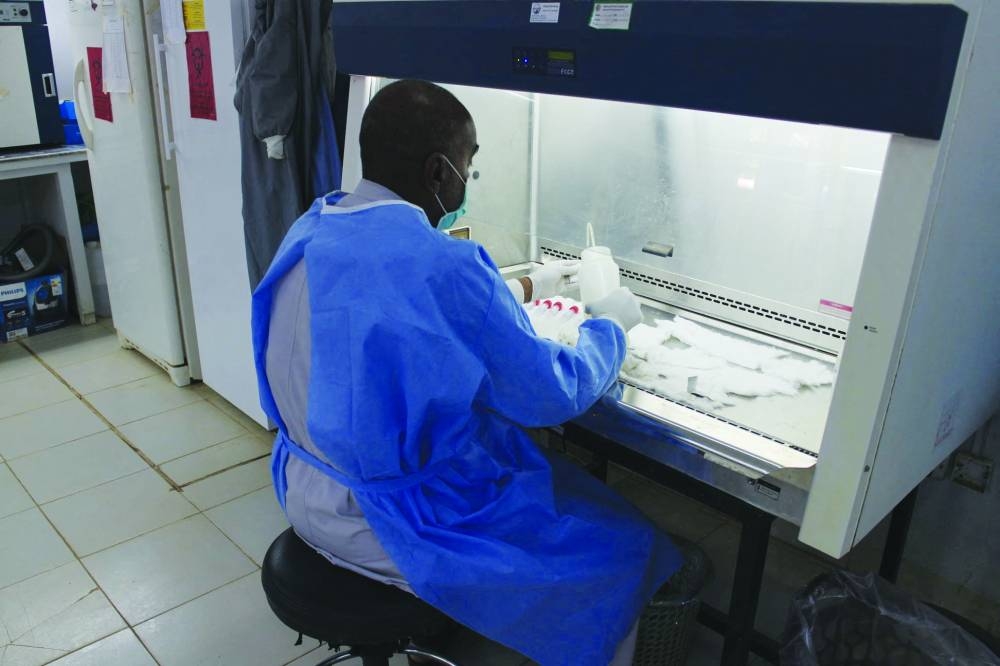 File photo show a staff member work at the National Public Health Laboratory in Khartoum, Sudan. Right: File photo shows staff work at National Public Health Laboratory in Khartoum, Sudan.