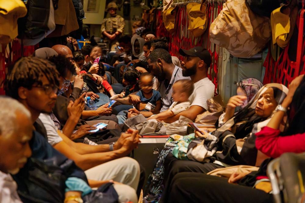British nationals sit inside an RAF aircraft, after being evacuated in Khartoum, Sudan. LPhot Mark Johnson/UK MOD/Pool via REUTERS