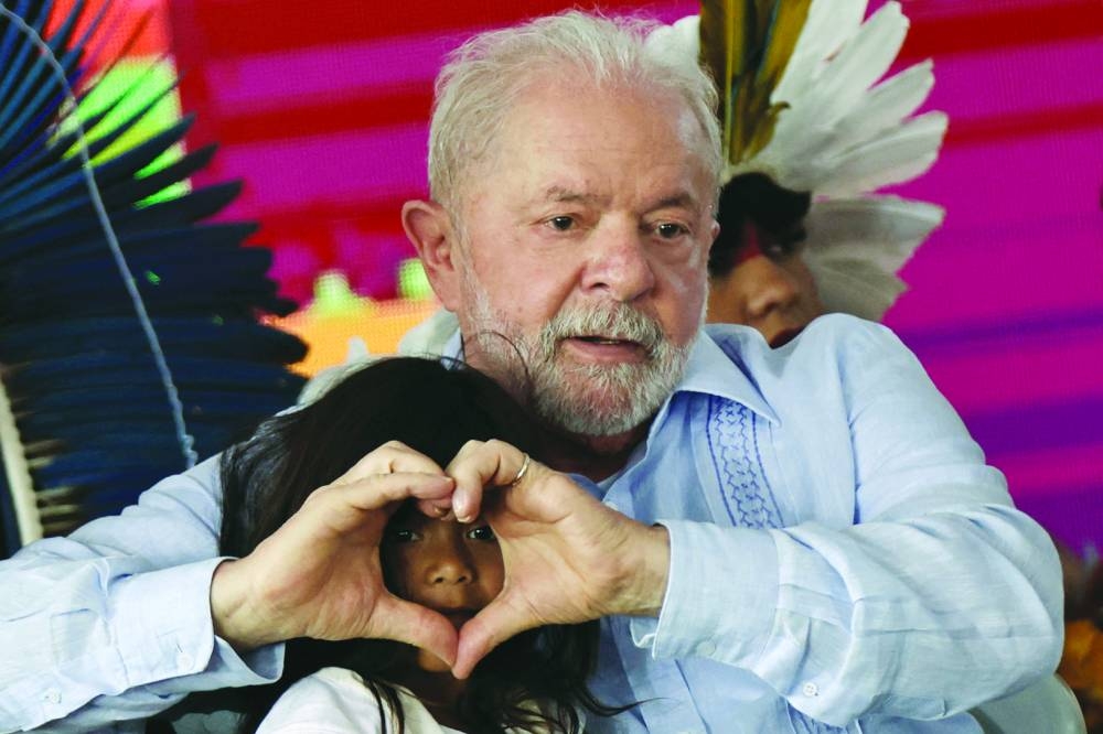 Lula with an indigenous child during the closing of the Terra Livre (Free Land) camp, a protest camp to demand the demarcation of land and to defend cultural rights, in Brasilia.