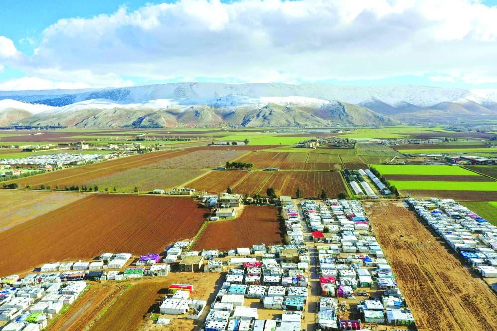 An aerial view shows an informal tent settlement housing Syrian refugees in the area of Delhamiyeh, in the central Bekaa Valley.