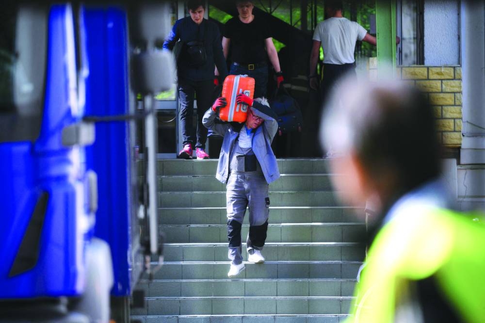 Authorities are seen gathered at a former Russian high school near Moscow’s embassy in Warsaw yesterday.