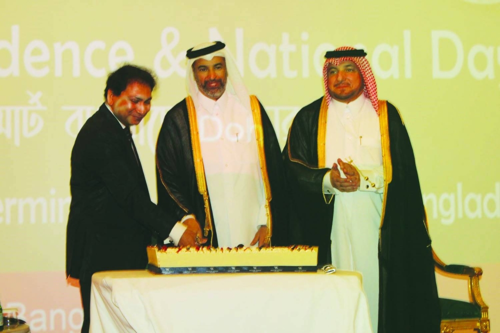 Bangladesh ambassador Md Nazrul Islam is joined by Qatar's Minister of Environment and Climate Change HE Sheikh Dr Faleh bin Nasser bin Ahmed bin Ali al-Thani in cutting a ceremonial cake at the event as Ministry of Foreign Affairs' Protocol Department director Ibrahim Fakhro looks on.