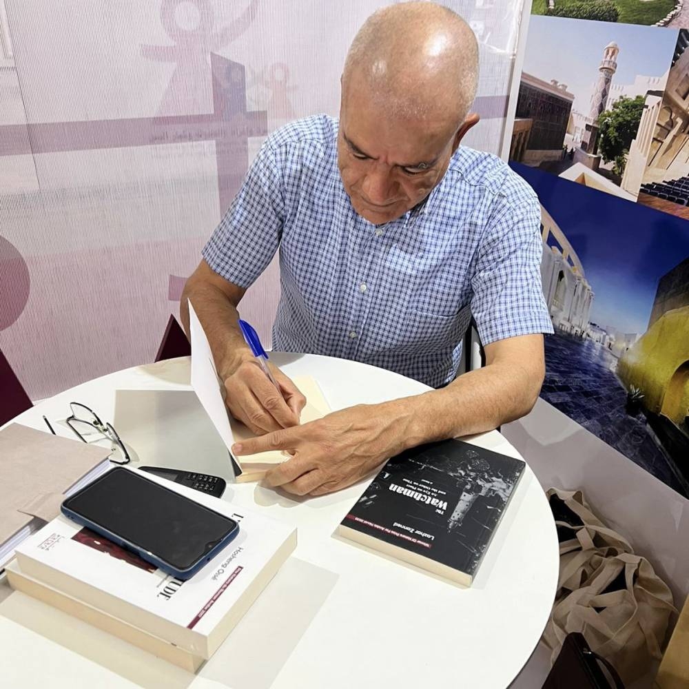 An author signing a book at TIBF.