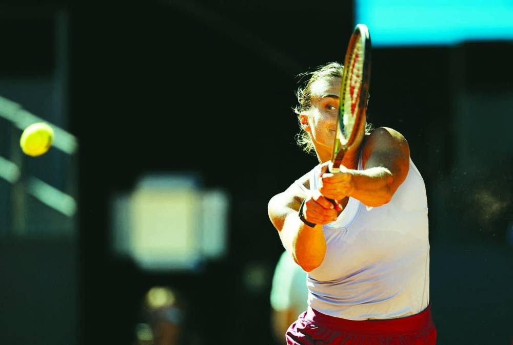 Belarus’ Aryna Sabalenka in action during her semi-final against Greece’s Maria Sakkari at the Madrid Open yesterday. Right: Russia’s Aslan Karatsev returns the ball to China’s Zhang Zhizhen during their Madrid Open quarter-final on Thursday. (Reuters/AFP)