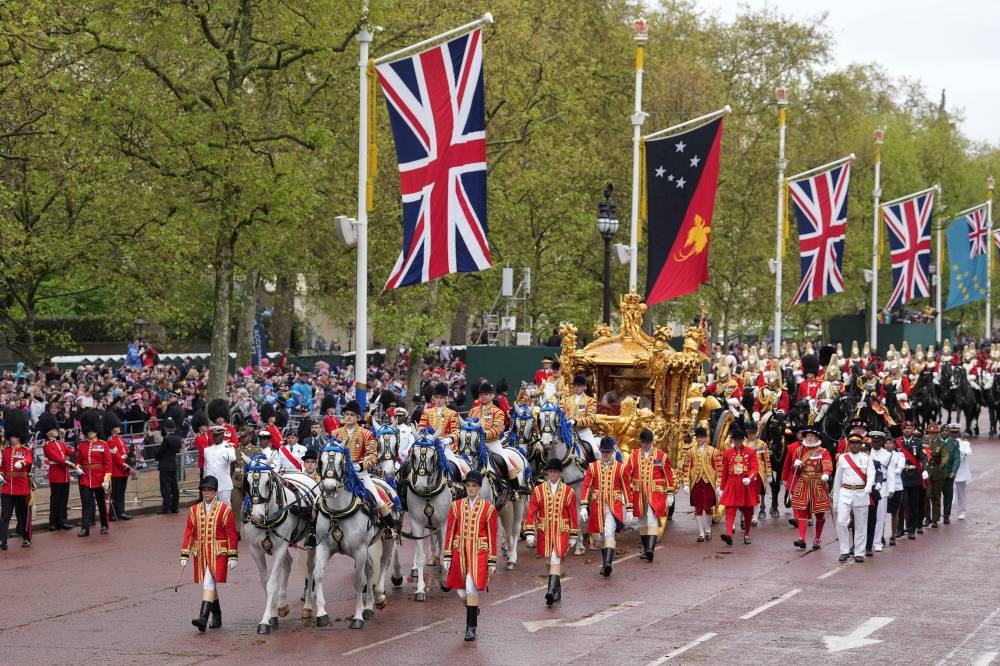 Britain's King Charles and Queen Camilla travel in the Gold State Coach, following their coronation ceremony, in London. REUTERS