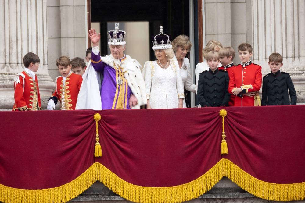 Britain's King Charles and Queen Camilla stand on the Buckingham Palace balcony following their coronation ceremony. REUTERS