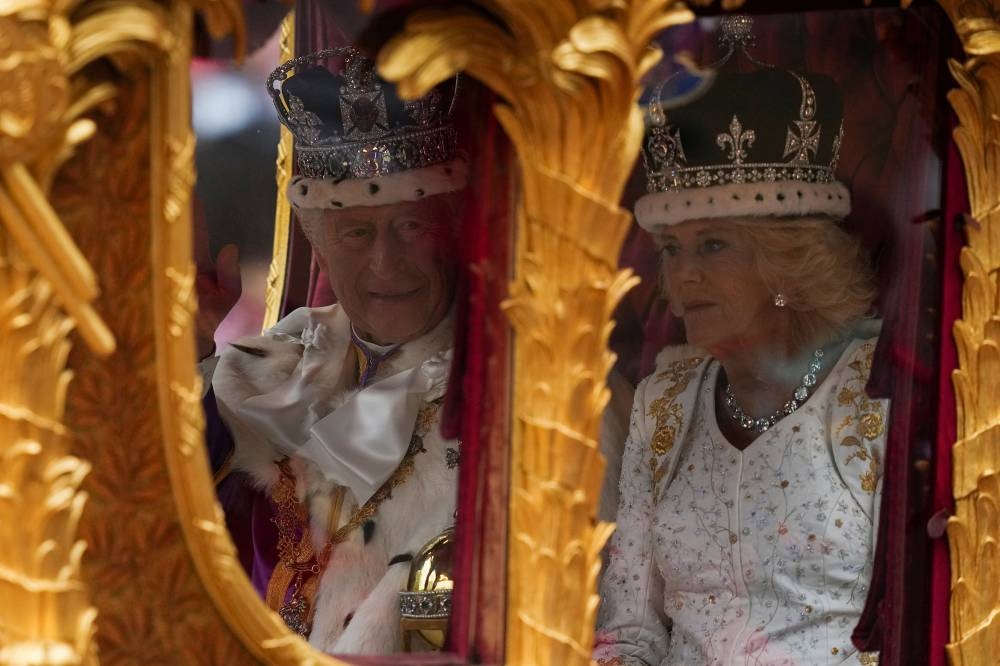 Britain's King Charles and Queen Camilla travel, following their coronation ceremony, in London. REUTERS