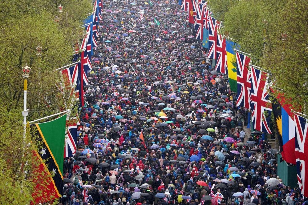 Crowds line the Mall after the coronation ceremonies of King Charles III and Queen Camilla in central London. AFP