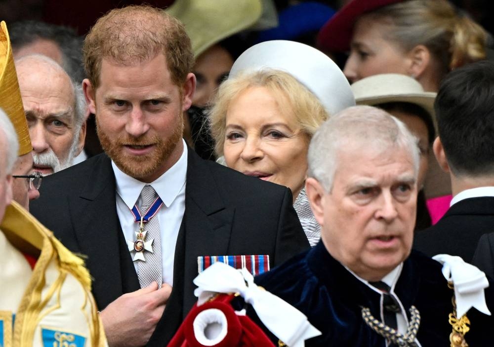 Britain's Prince Harry, Duke of Sussex (L) and Britain's Prince Andrew, Duke of York (R) leave after attending the coronations of Britain's King Charles III and Britain's Camilla, Queen Consort, at Westminster Abbey in central London. AFP
