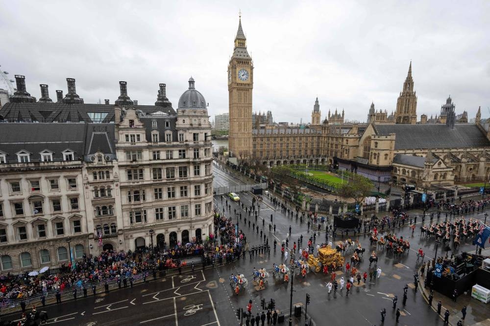  Britain's King Charles III and Britain's Queen Camilla travel in the Gold State Coach, built in 1762, back to Buckingham Palace from Westminster Abbey in central London. AFP
