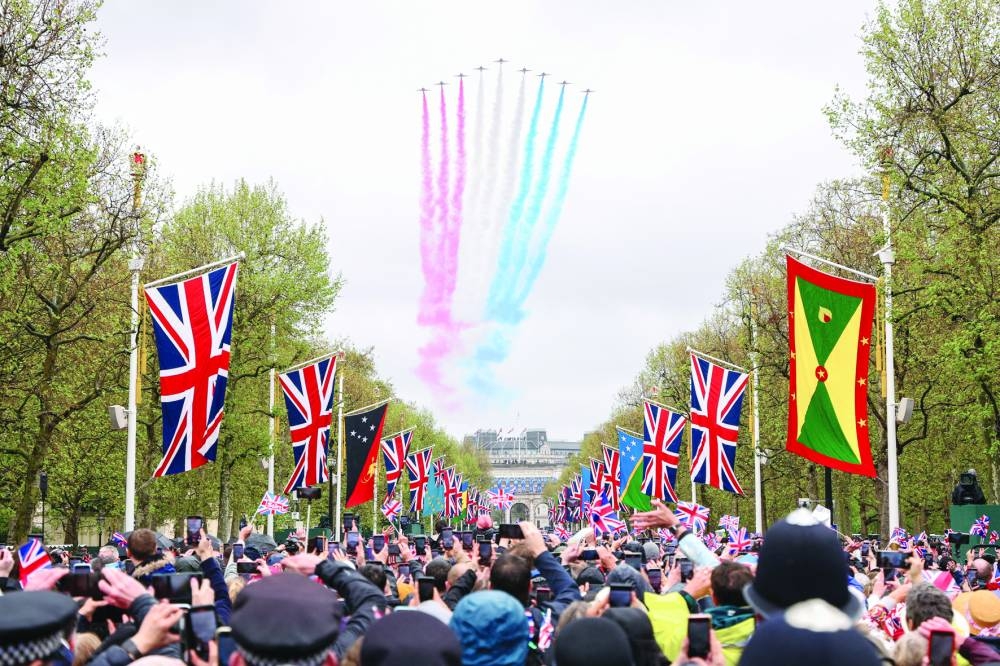 The Royal Air Force Aerobatic Team, otherwise known as The Red Arrows, fly down The Mall and over Buckingham Palace.