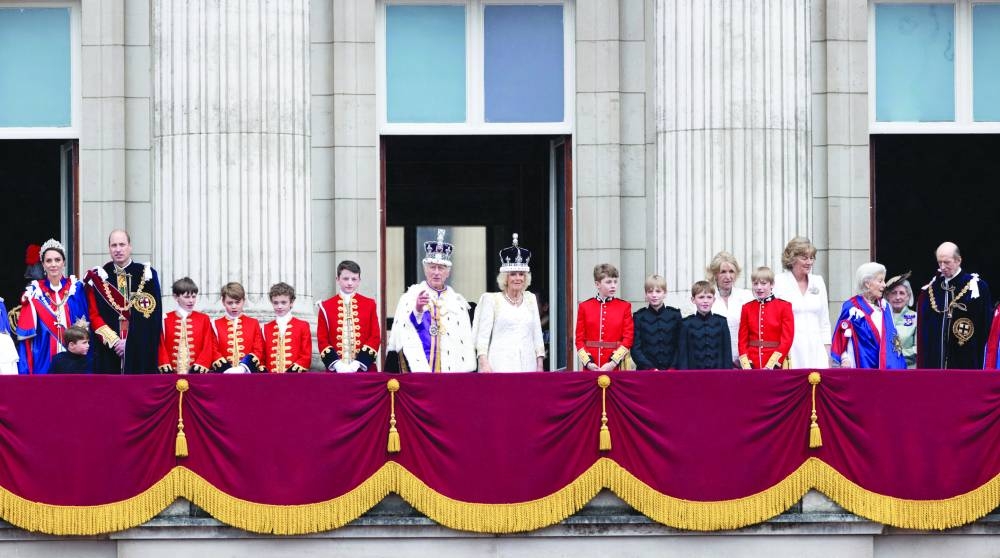 King Charles III and Queen Camilla stand on the balcony of Buckingham Palace following their coronation.