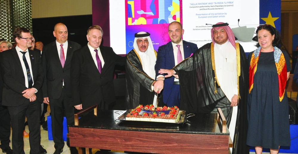 The EU ambassador to Qatar Dr Cristian Tudor is joined by Qatar's Minister of Transport HE Jassim Seif Ahmed al-Sulaiti, Ministry of Foreign Affairs' Protocol Department director Ibrahim Fakhro in cutting a ceremonial cake at the Europe Day celebrations as other dignitaries look on. PICTURE: Shaji Kayamkulam.