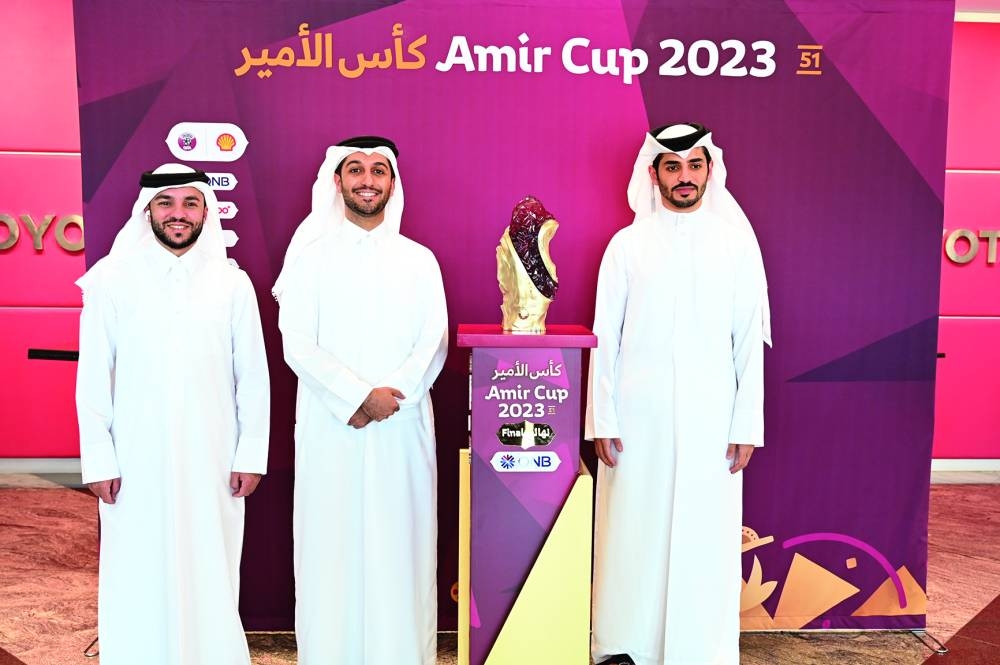 Officials pose with the Amir Cup trophy at Al Abdulghani Tower.