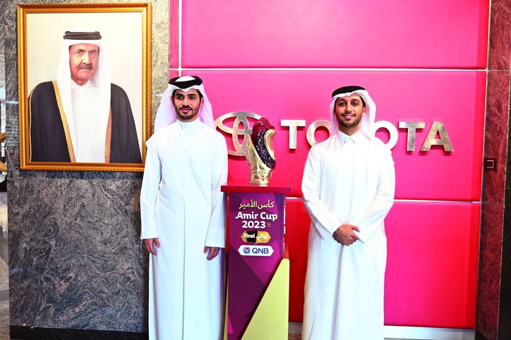 Officials pose with the Amir Cup trophy at Al Abdulghani Tower.
