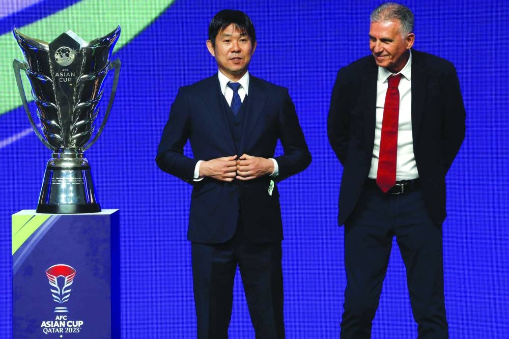 Qatar’s coach Carlos Queiroz (right) and Japan’s coach Hajime Moriyasu during the draw for the AFC Asian Cup in Doha on Thrusday. (AFP)