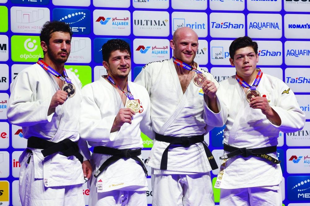 (L to R) Georgia’s Lasha Bekauri, Georgia’s Luka Maisuradze, Sweden’s Marcus Nyma, and Japan’s Sanshiro Murao pose on the podium with their medals at the World Judo Championship in Doha on Thursday. (AFP)