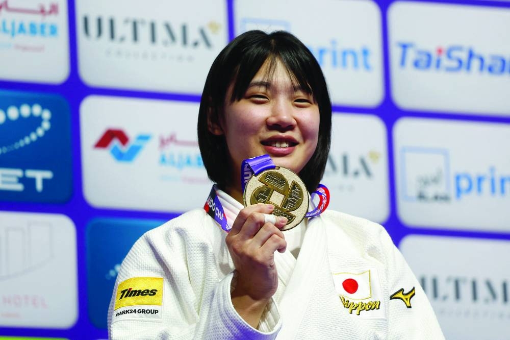 Japan’s Saki Niizoe poses on the podium with her gold medal at the World Judo Championship in Doha on Thursday. (AFP)