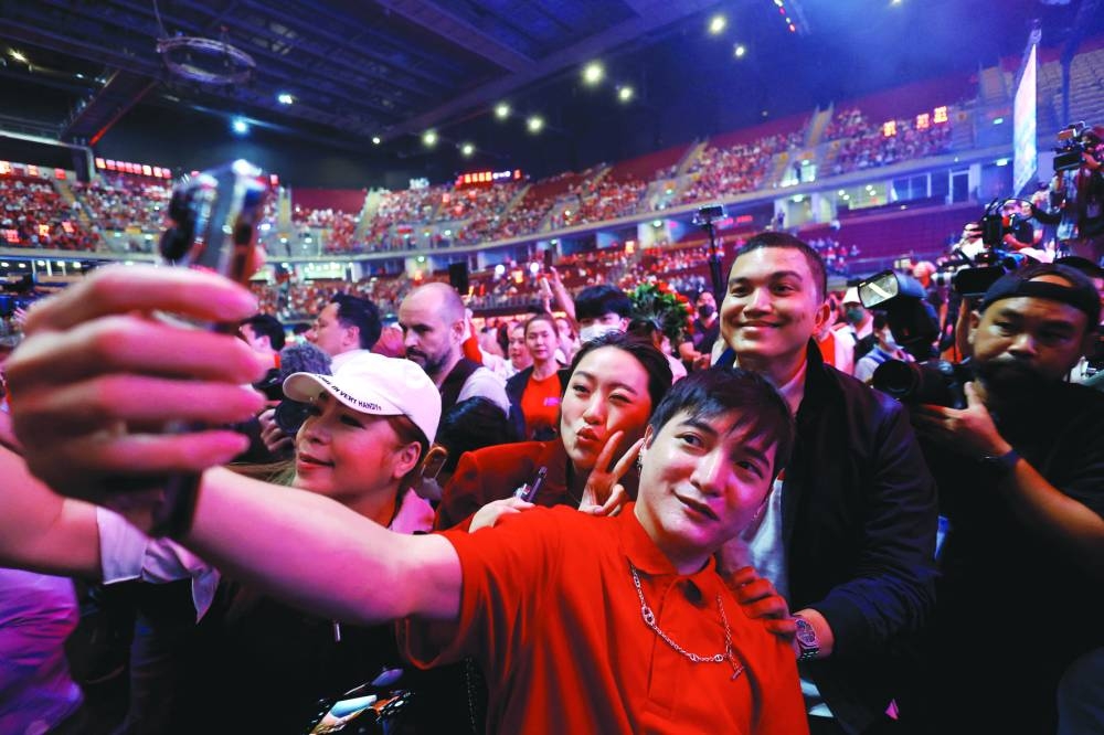 
Paetongtarn Shinawatra, Pheu Thai’s leading prime ministerial candidate, poses for a selfie during a major rally event ahead of the upcoming election, in Bangkok. 