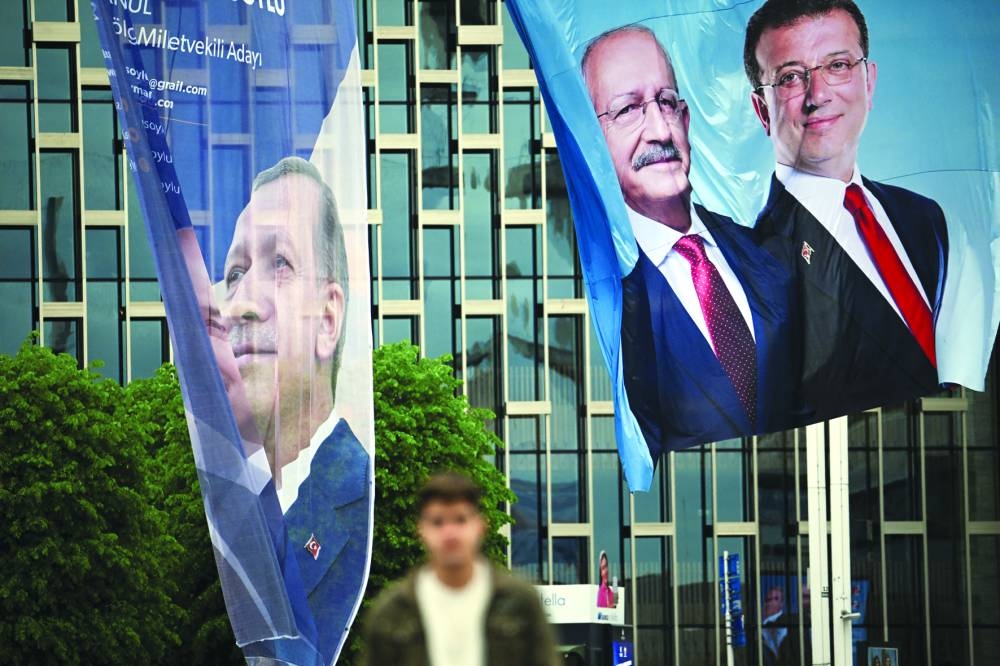 
Banners of Turkish President Erdogan and Kilicdaroglu, presidential candidate of Turkiye’s main opposition alliance with Istanbul Mayor Ekrem Imamoglu, flutter on a street ahead of tomorrow’s presidential and parliamentary elections, in Istanbul. 