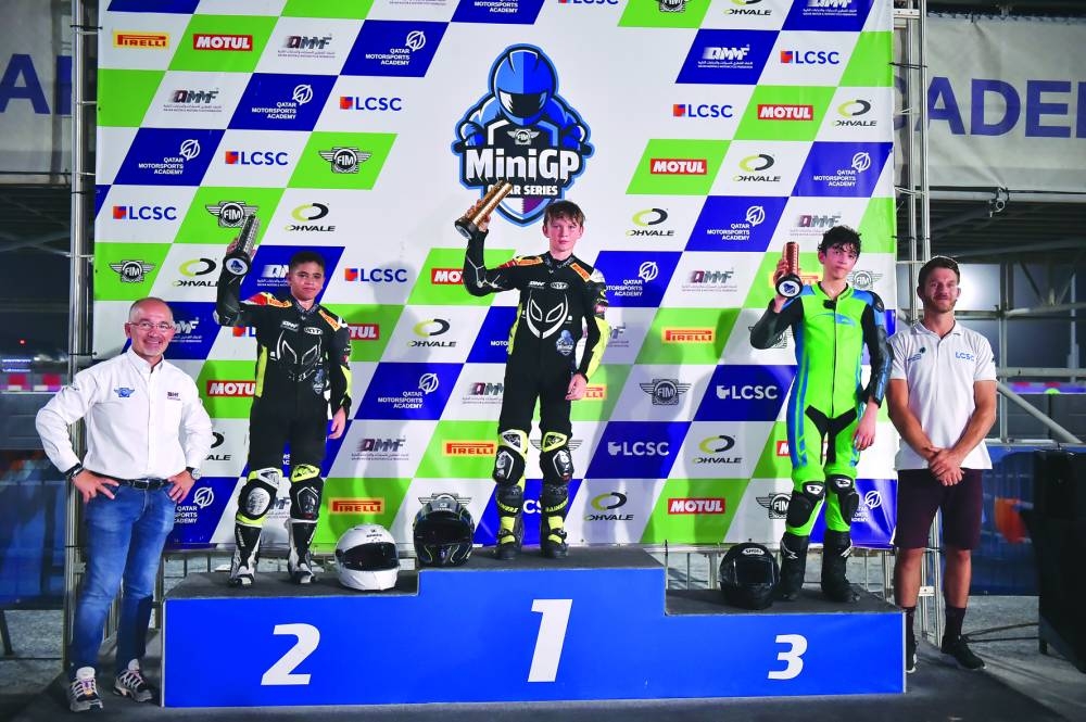 Twelve-year-old French rider Nolann Macary (centre) won both races at the 2023 FIM Mini GP Qatar Round 3, edging Egyptian 15-year-old Mohmoud Elbanna (left) in thrilling duels on Saturday.