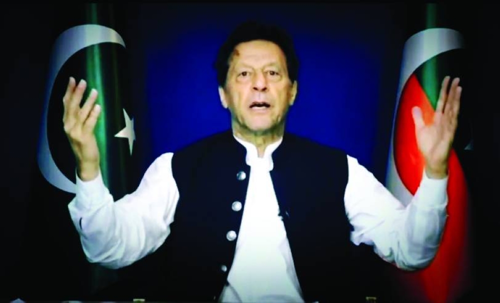 Pakistan’s former prime minister Imran Khan addressing the nation from his Zaman Park residence in Lahore yesterday. (AFP)