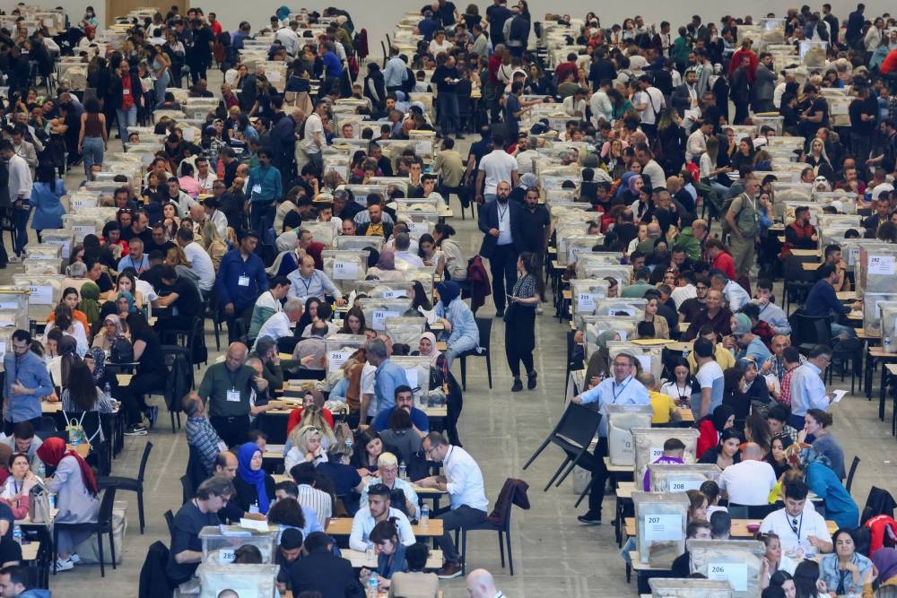 Election officials wait to count votes from abroad on the day of Turkiye's presidential and parliamentary elections, in Ankara. REUTERS/Yves Herman