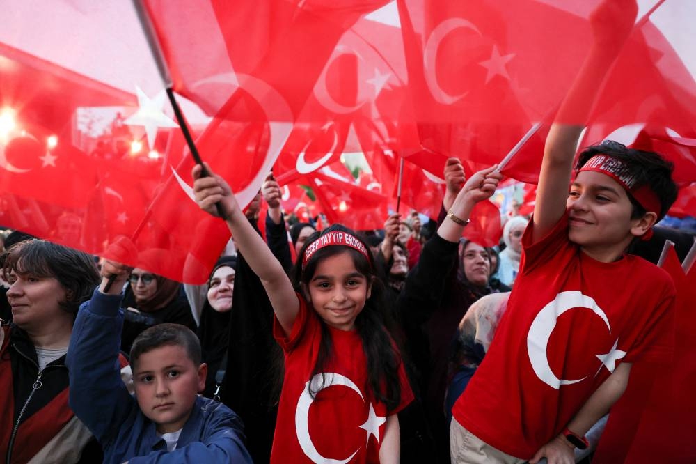 Supporters of Turkish President Recep Tayyip Erdogan and AK Party (AKP) react after early exit polls at the AK Party headquarters in Ankara. REUTERS/Umit Bektas
