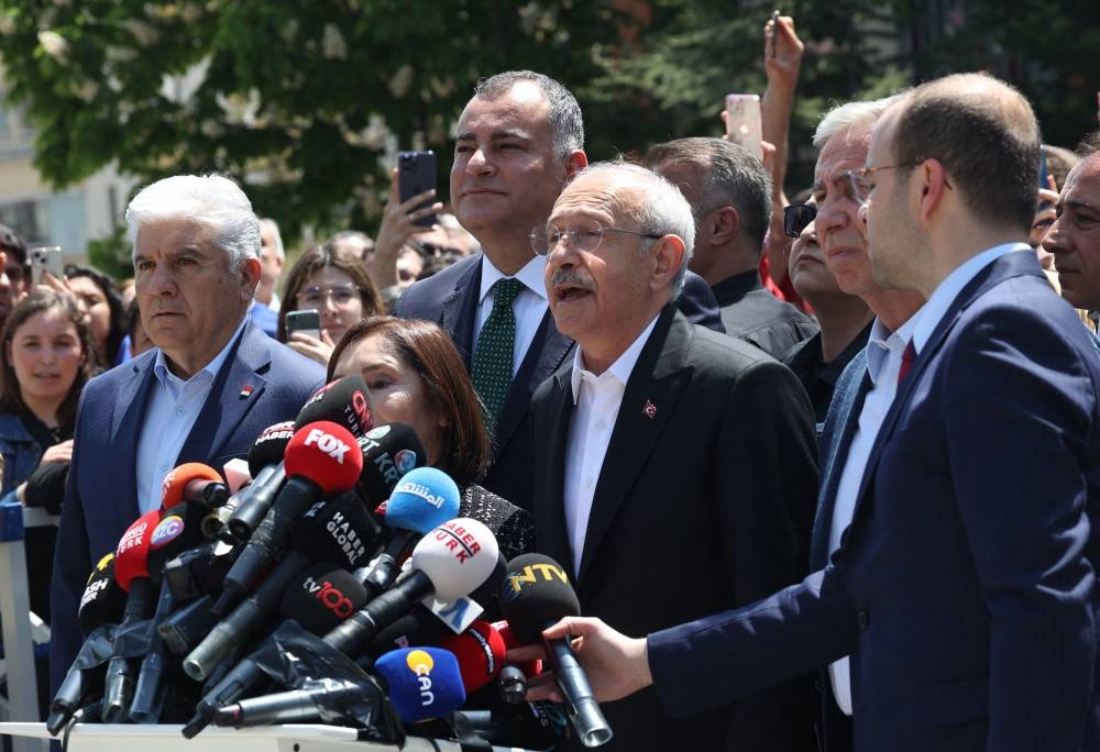 Kemal Kilicdaroglu (C) the 74-year-old leader of the center-left, pro-secular Republican People's Party, or CHP speaks after casting his vote at a polling station in Ankara. Adem ALTAN / AFP