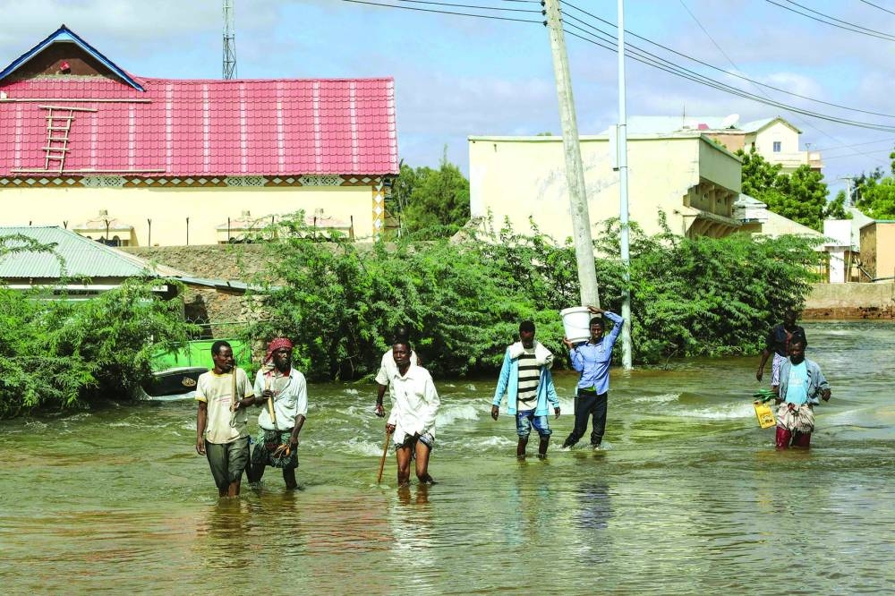 Men walk through floodwater in Beledweyne, central Somalia.
