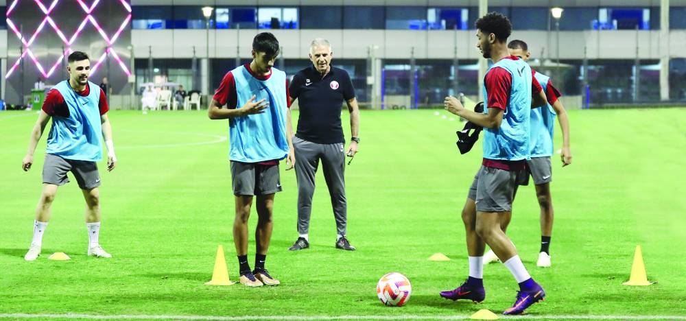
Qatar’s coach Carlos Queiroz (centre) keeps a close eye on his players during a training camp at the Aspire Zone.
 