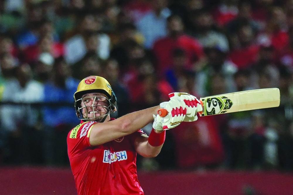 Punjab Kings’ Liam Livingstone plays a shot during the IPL match against Delhi Capitals at the Himachal Pradesh Cricket Association Stadium in Dharamsala yesterday. Right:  Delhi Capitals’ batsman Rilee Rossouw plays a sweep shot against Punjab Kings on Wednesday. (AFP)