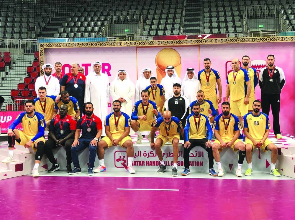 Runners-up Al Gharafa pose with Qatar Olympic Committee Second Vice-President Dr Thani bin Abdulrahman al-Kuwari and other officials after the final.