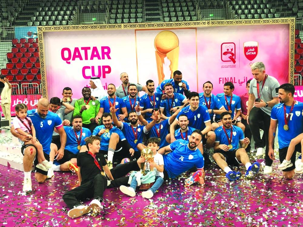 Al Wakrah players celebrate with the trophy after winning the Qatar Cup handball tournament at the Al Duhail Sports Hall on Saturday.
